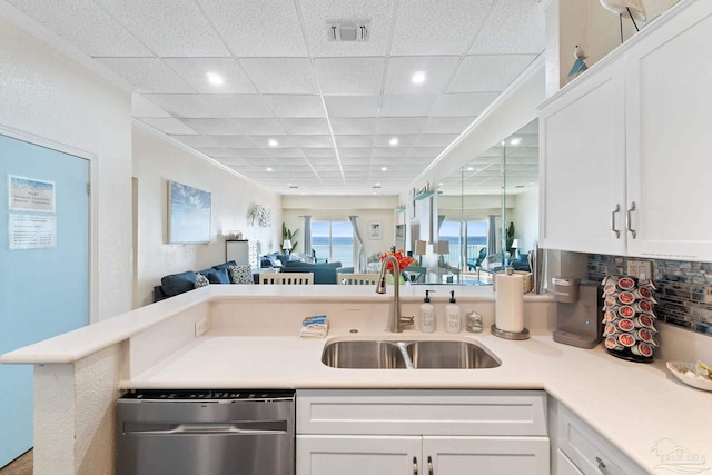 kitchen featuring light countertops, dishwasher, and white cabinetry