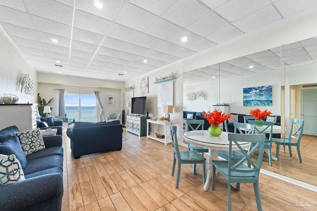 dining space with a drop ceiling