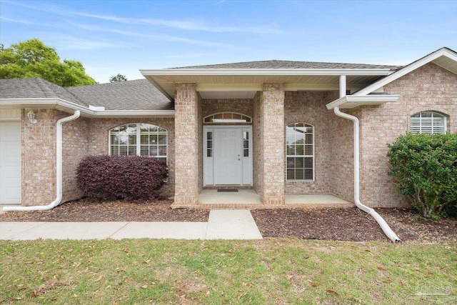 doorway to property with a yard