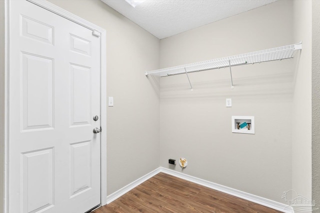 laundry area with hardwood / wood-style floors, hookup for a washing machine, and a textured ceiling