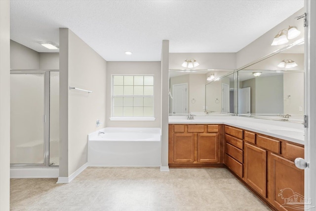 bathroom with vanity, plus walk in shower, and a textured ceiling