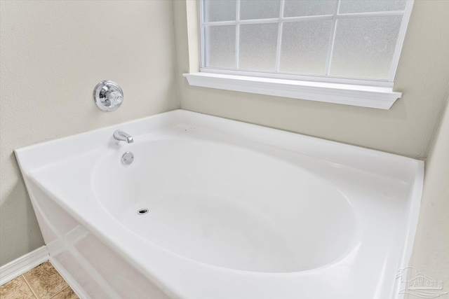 bathroom featuring tile patterned flooring and a bathing tub