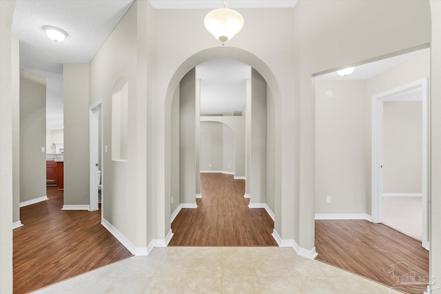 hallway with hardwood / wood-style flooring