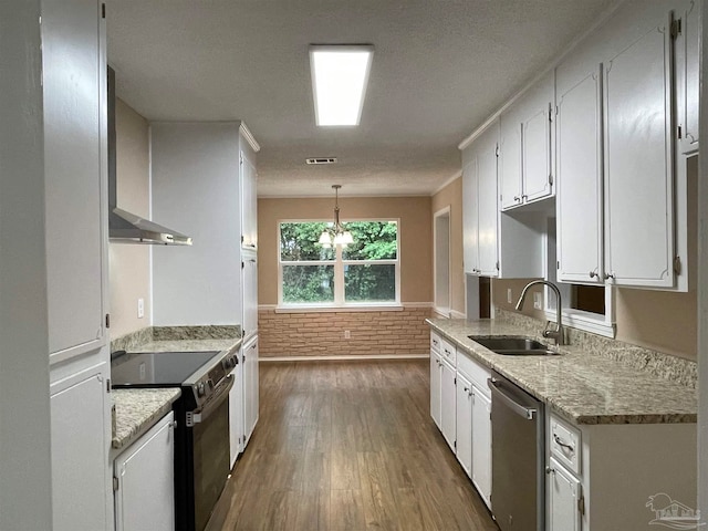 kitchen featuring pendant lighting, sink, stainless steel dishwasher, white cabinetry, and range