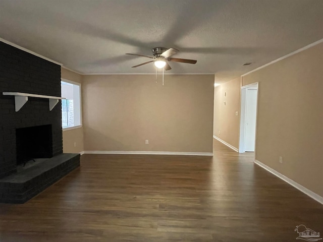 unfurnished living room featuring dark hardwood / wood-style flooring, a brick fireplace, ceiling fan, and ornamental molding