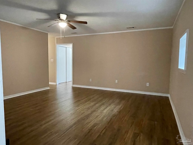 spare room featuring dark hardwood / wood-style floors, ceiling fan, and crown molding