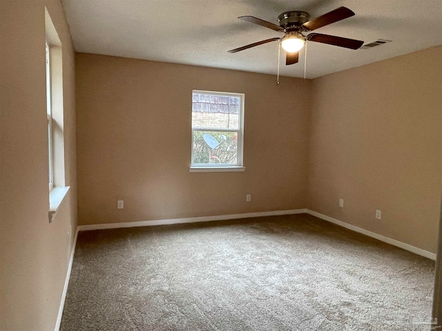 spare room featuring ceiling fan and carpet floors