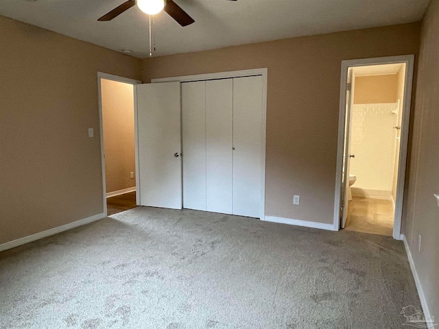 unfurnished bedroom with carpet flooring, connected bathroom, a closet, and ceiling fan