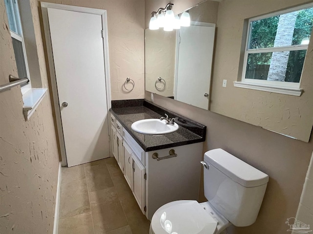 bathroom with tile patterned floors, vanity, and toilet