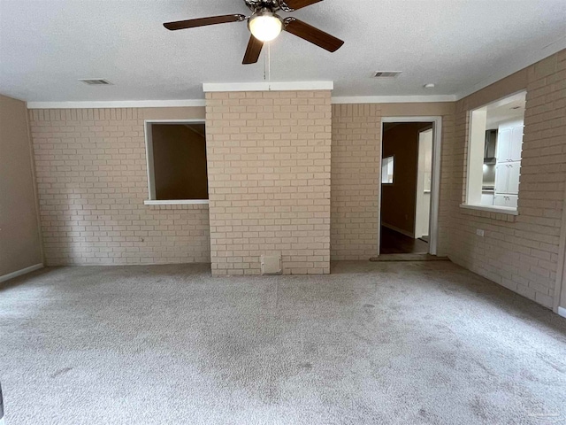 spare room with carpet and brick wall