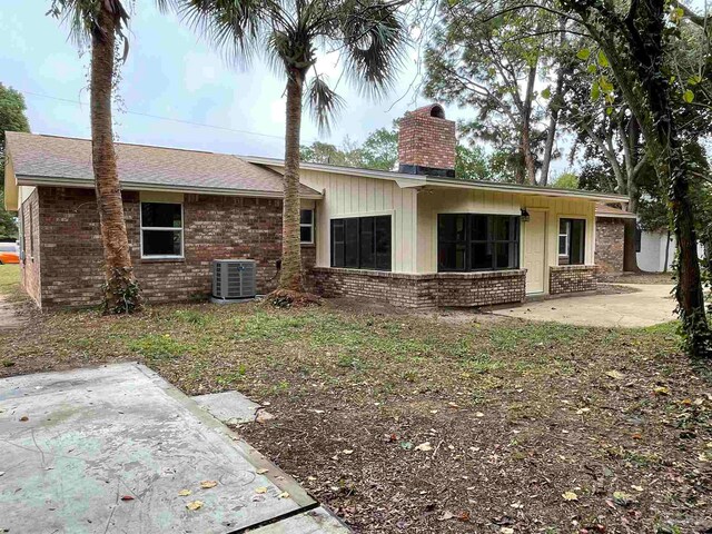 view of front of property with cooling unit and a patio