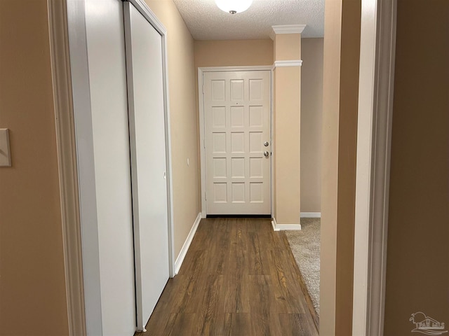 hallway featuring a textured ceiling and dark hardwood / wood-style floors