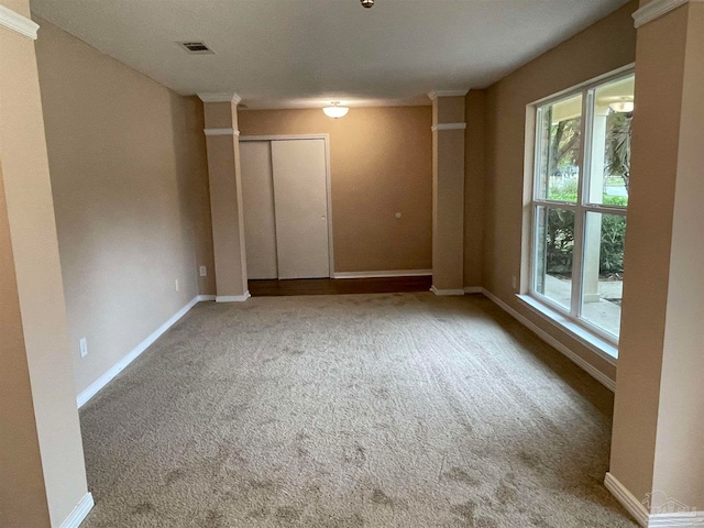 spare room featuring carpet flooring and plenty of natural light