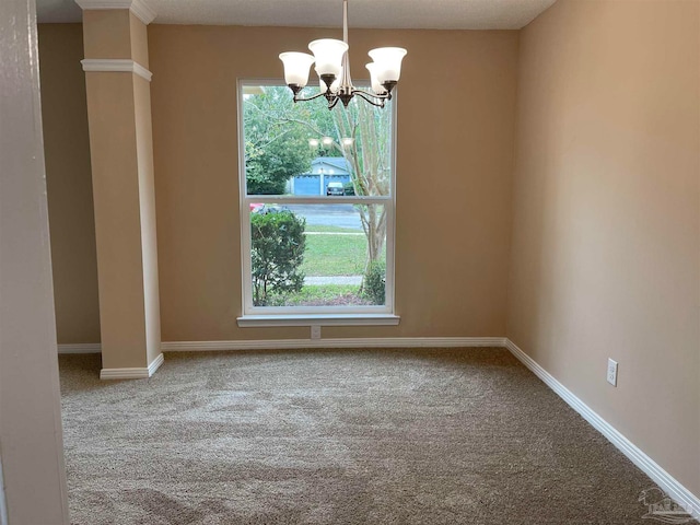 carpeted spare room featuring a chandelier