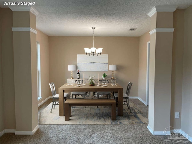 carpeted dining room with a chandelier, a textured ceiling, and crown molding