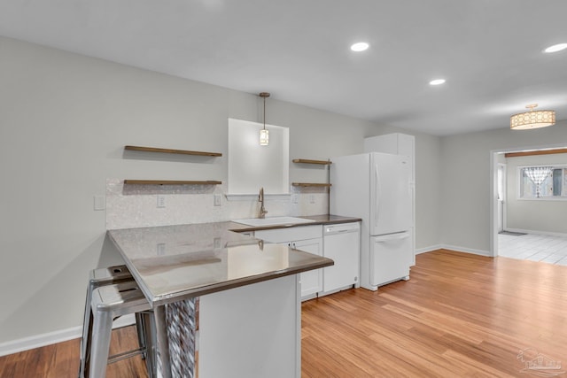 kitchen with open shelves, white appliances, a sink, and white cabinetry