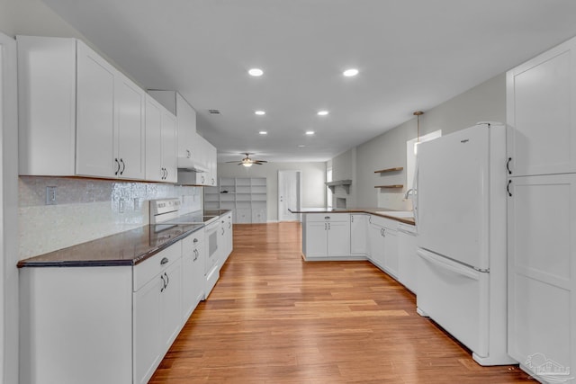 kitchen with ceiling fan, a peninsula, white appliances, light wood-type flooring, and tasteful backsplash