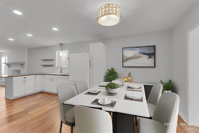 dining area with recessed lighting and light wood finished floors