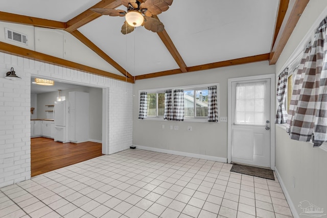 interior space featuring light tile patterned floors, visible vents, lofted ceiling with beams, brick wall, and ceiling fan