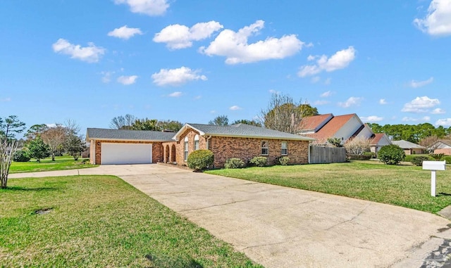 ranch-style house with a garage, brick siding, fence, concrete driveway, and a front lawn