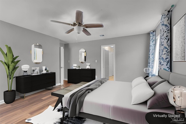 bedroom with light wood-style floors, ceiling fan, and baseboards