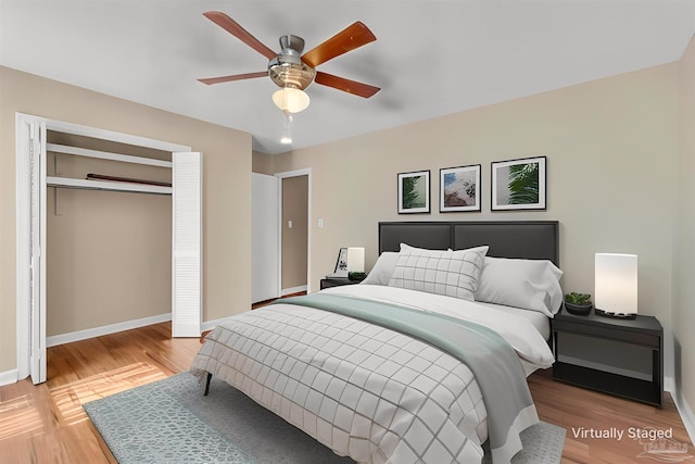 bedroom with a ceiling fan, a closet, baseboards, and wood finished floors