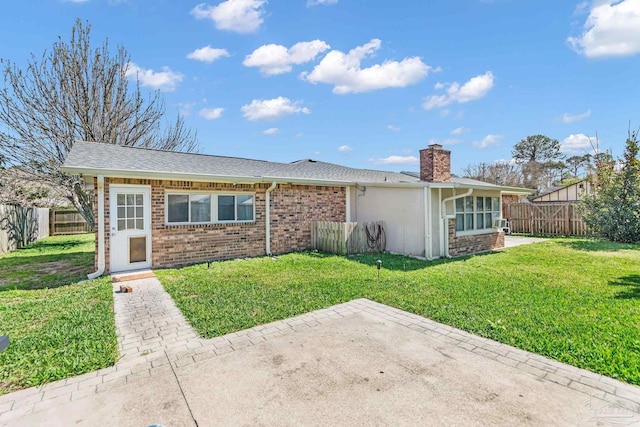 ranch-style house featuring brick siding, a fenced backyard, a front lawn, and a patio