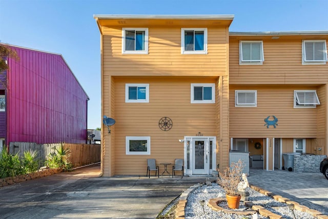 rear view of house featuring a patio area and a wall unit AC