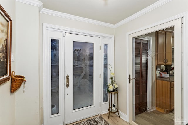 doorway to outside with light hardwood / wood-style floors and ornamental molding