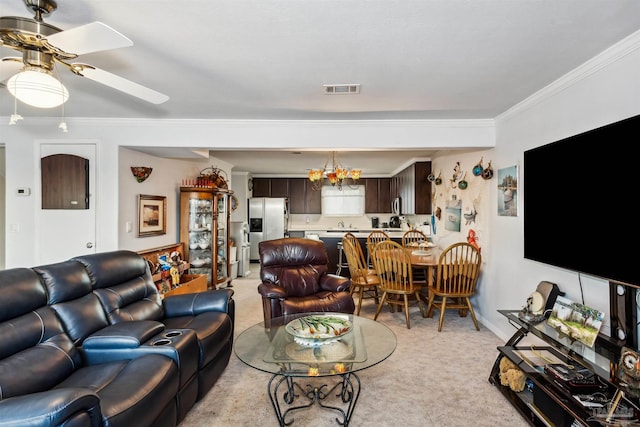 carpeted living room with ceiling fan with notable chandelier and ornamental molding