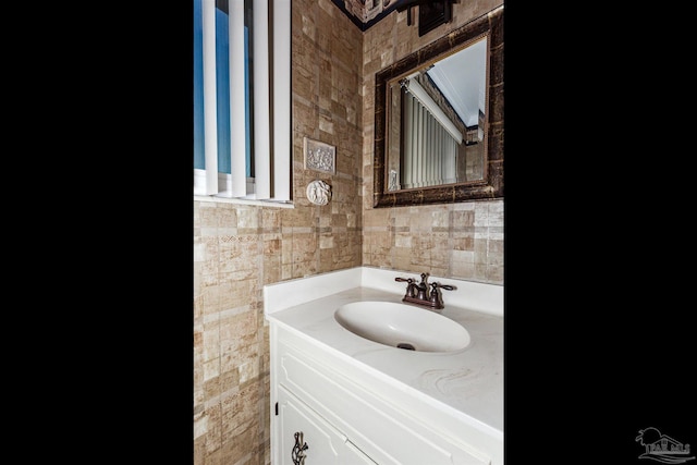 bathroom featuring vanity and tile walls