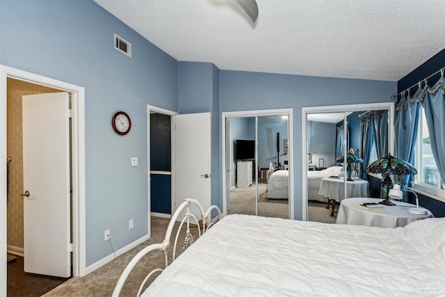 bedroom with carpet, a textured ceiling, and vaulted ceiling