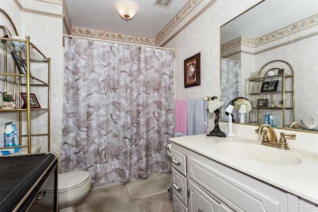 bathroom with vanity, a textured ceiling, and toilet