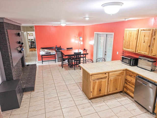 kitchen featuring dishwasher, french doors, a peninsula, and tile counters