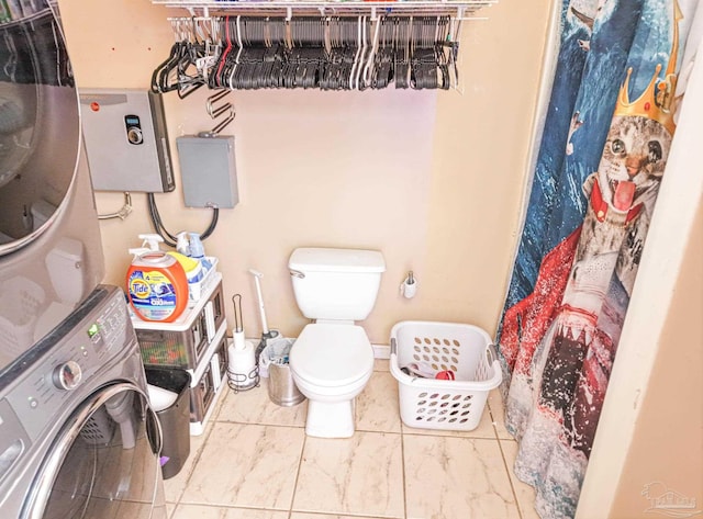 bathroom with stacked washer and clothes dryer, toilet, and a shower with curtain