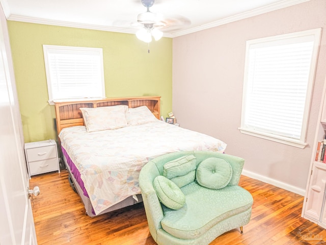 bedroom featuring a ceiling fan, baseboards, light wood-type flooring, and ornamental molding