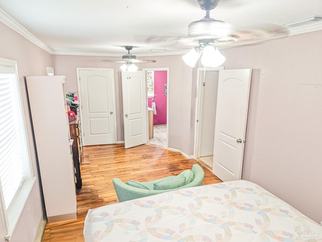 bedroom with light wood-type flooring, a ceiling fan, visible vents, and crown molding