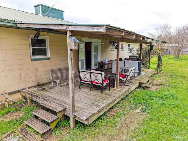 wooden deck with a yard and area for grilling