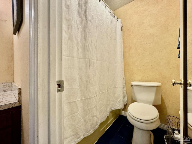 full bath with curtained shower, tile patterned flooring, toilet, and baseboards