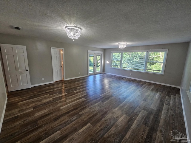 interior space featuring french doors, visible vents, dark wood-type flooring, a chandelier, and baseboards