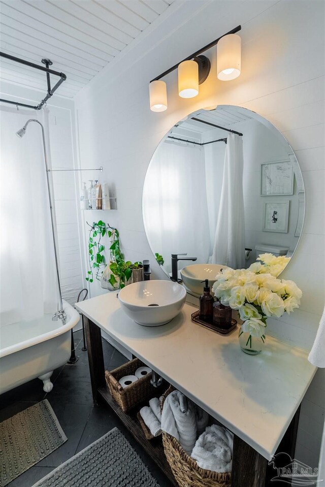 bathroom featuring tile patterned flooring, sink, and shower / bath combo