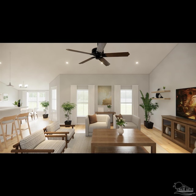 living room with ceiling fan, lofted ceiling, plenty of natural light, and light hardwood / wood-style flooring