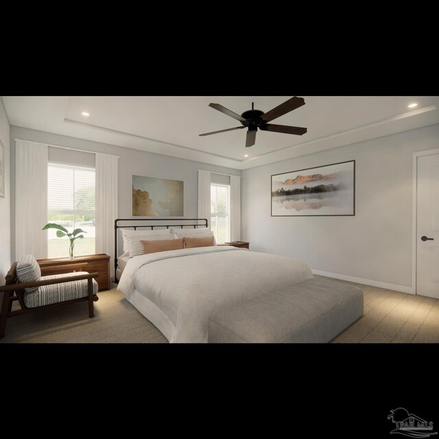 bedroom featuring ceiling fan and a raised ceiling