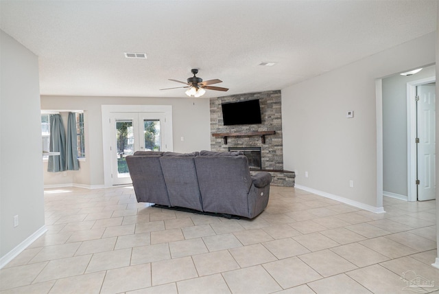 4005 Shorewood Dr, Pensacola, FL 32507 - living room with french doors, baseboards, visible vents, a ceiling fan, and a stone fireplace