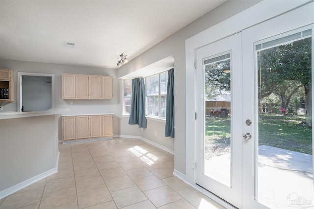 4005 Shorewood Dr, Pensacola, FL 32507 - kitchen with light countertops, light tile patterned floors, light brown cabinetry, and baseboards