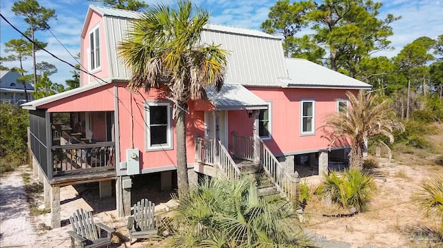 back of property featuring metal roof