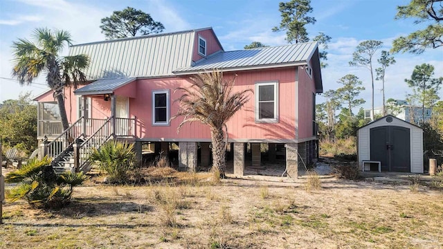 view of front of home featuring metal roof, a shed, and an outdoor structure