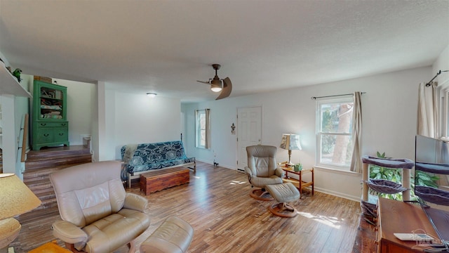 living room with ceiling fan, wood finished floors, and baseboards