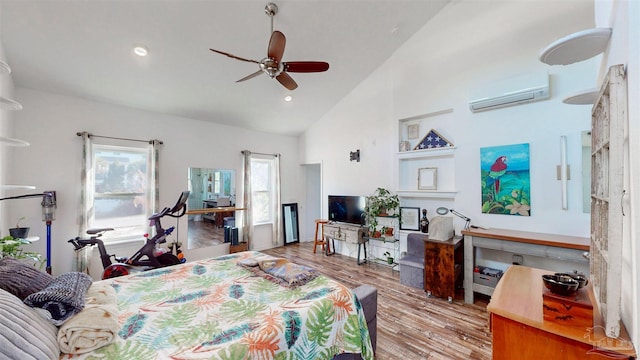 bedroom with a ceiling fan, wood finished floors, an AC wall unit, high vaulted ceiling, and recessed lighting