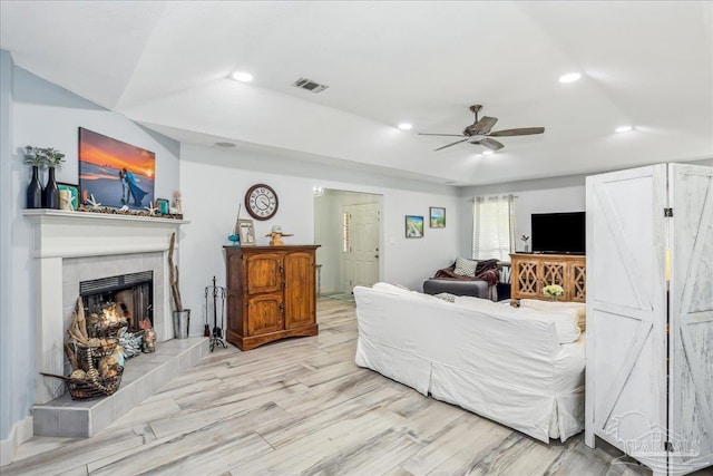 6961 Elliots Gin Ln, Navarre, FL 32566 - living room featuring ceiling fan, recessed lighting, light wood-style floors, and a tiled fireplace